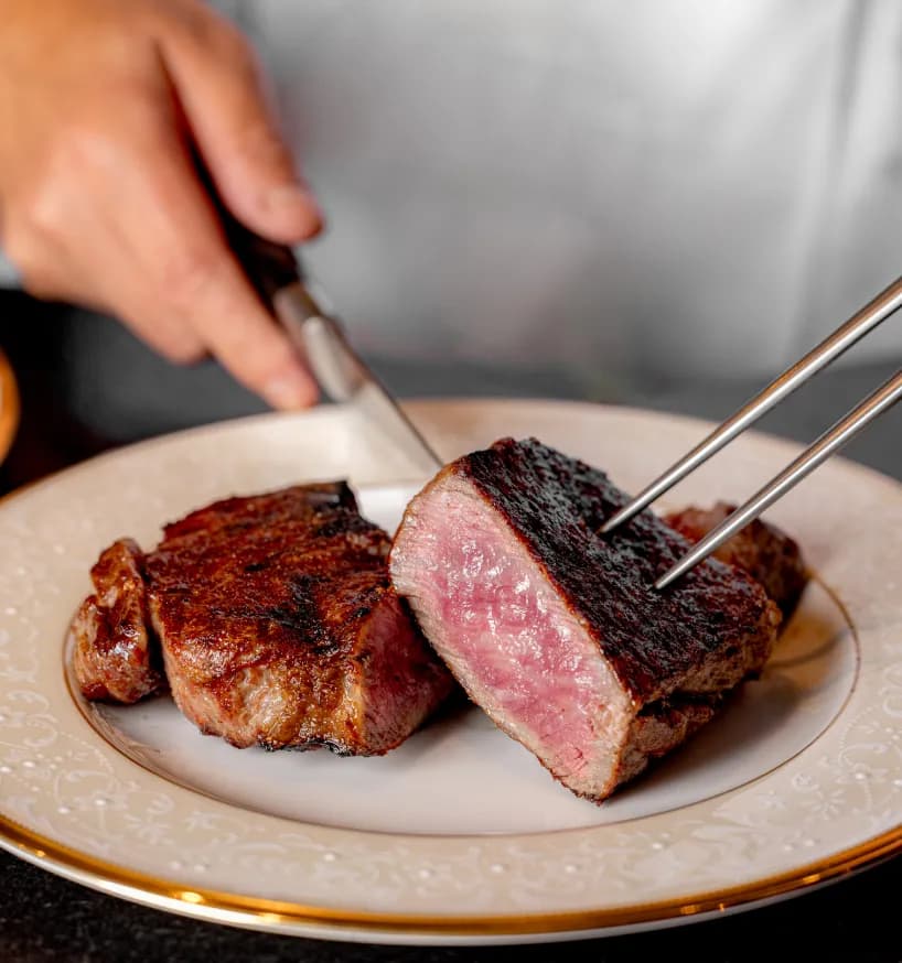 Tajima Wagyu sirloin being sliced at the table at Aragawa